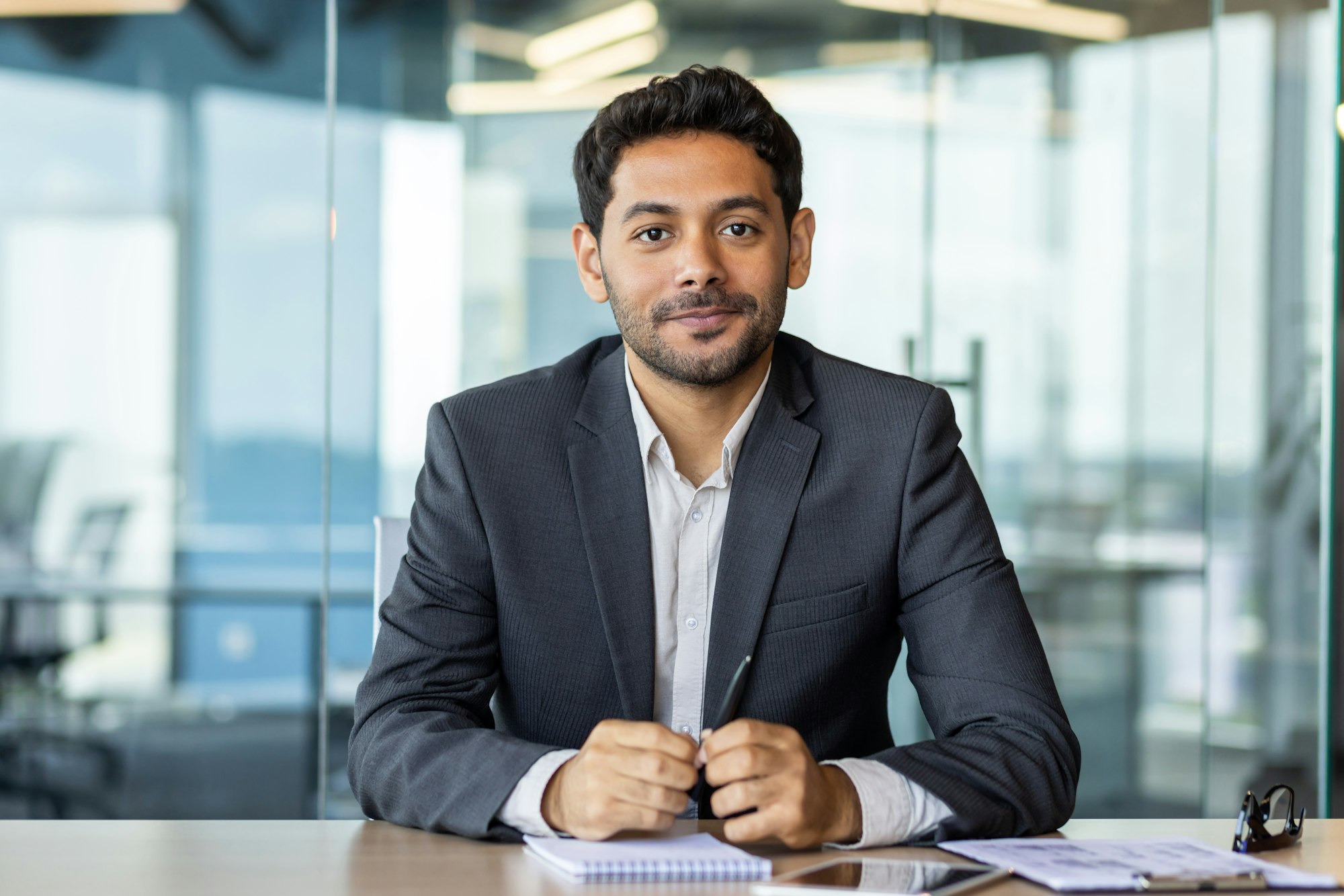 Portrait of a young investor banker at the workplace inside the bank office, a businessman in a